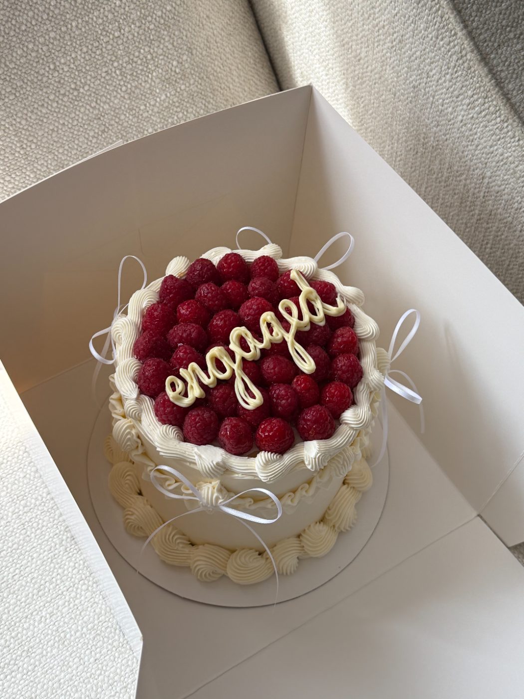 Engagement cake with raspberries and bows