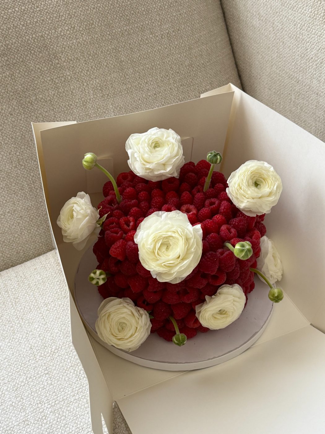 Raspberry cake with white ranunculus